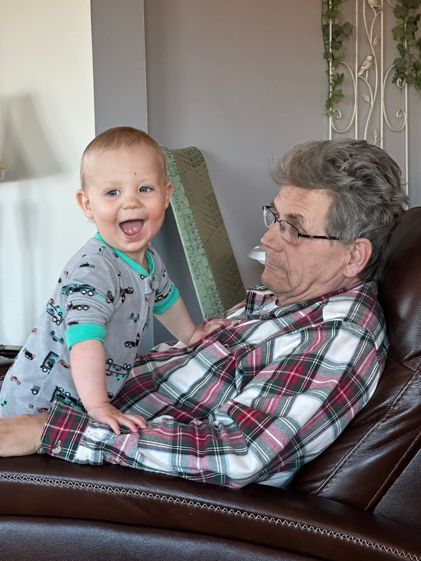A young child smiling with his grandfather