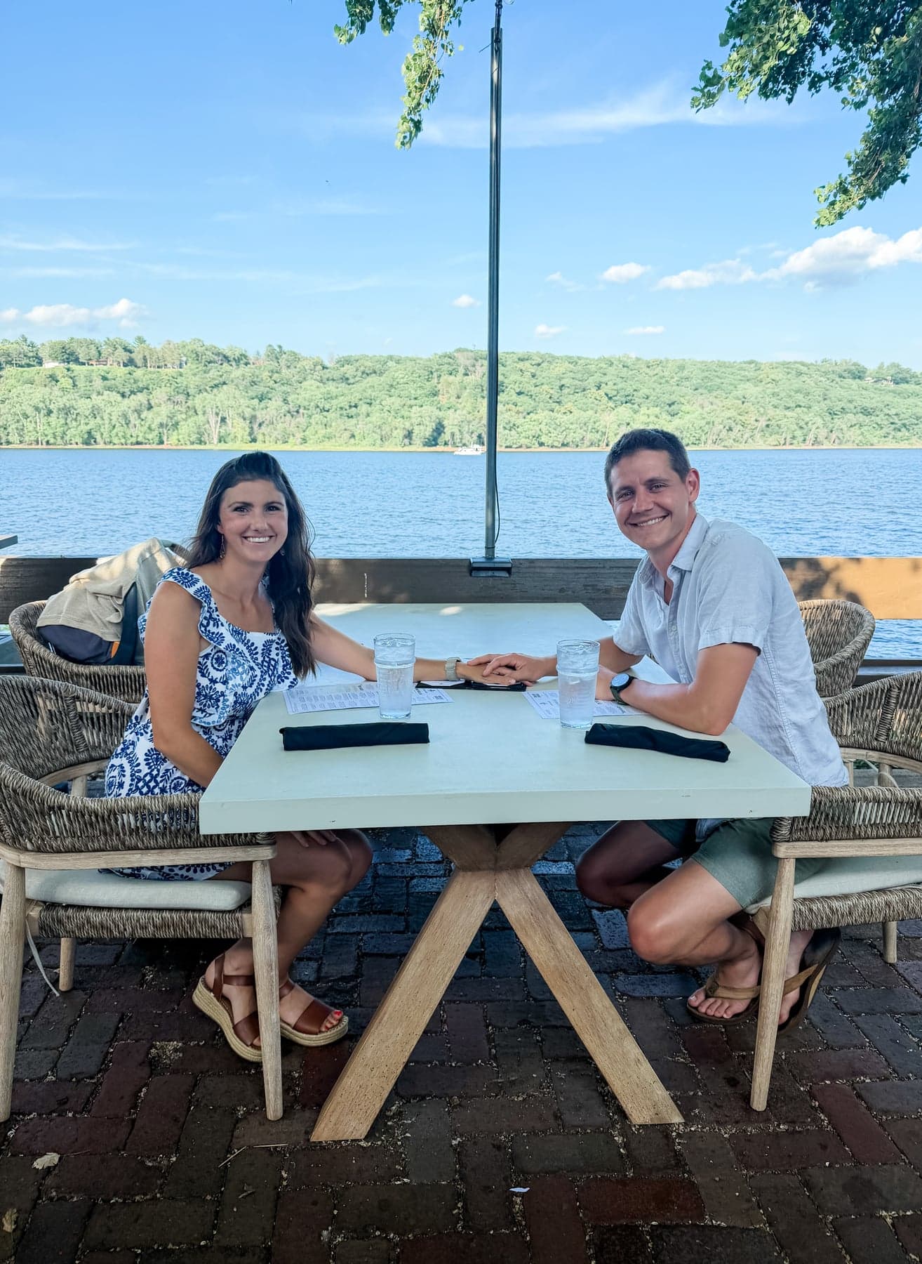 A couple sharing a meal beside a lake